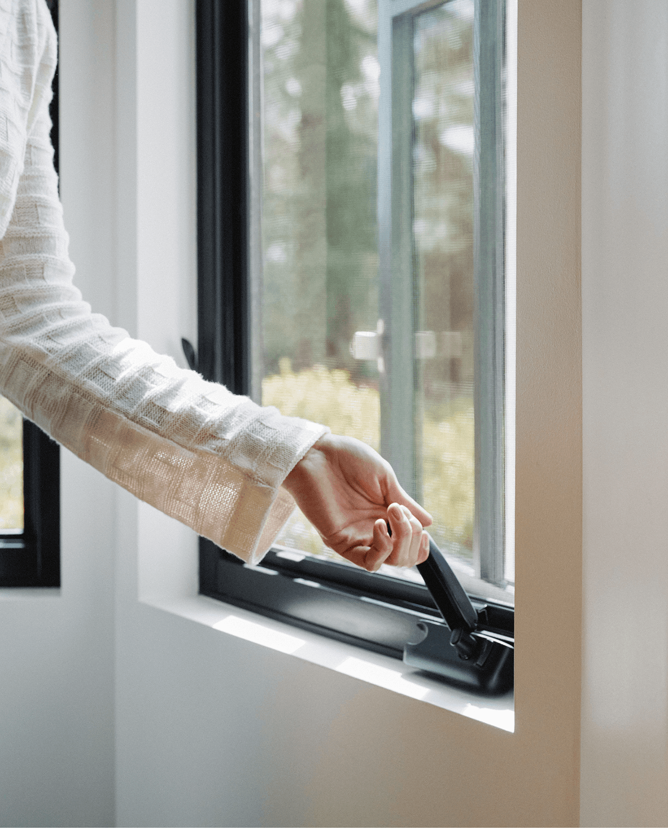 Person turning folding handle crank out Marvin Ultimate Casement Narrow frame window