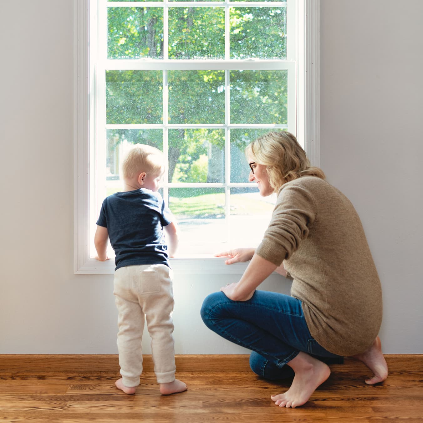 Mom and son in front of Marvin Essential Single Hung window