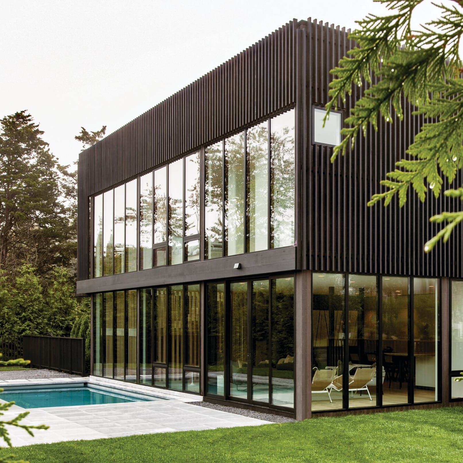 Modern home exterior view with several black Marvin Modern Direct Glaze windows in a row.